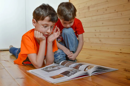 Two children are reading a book